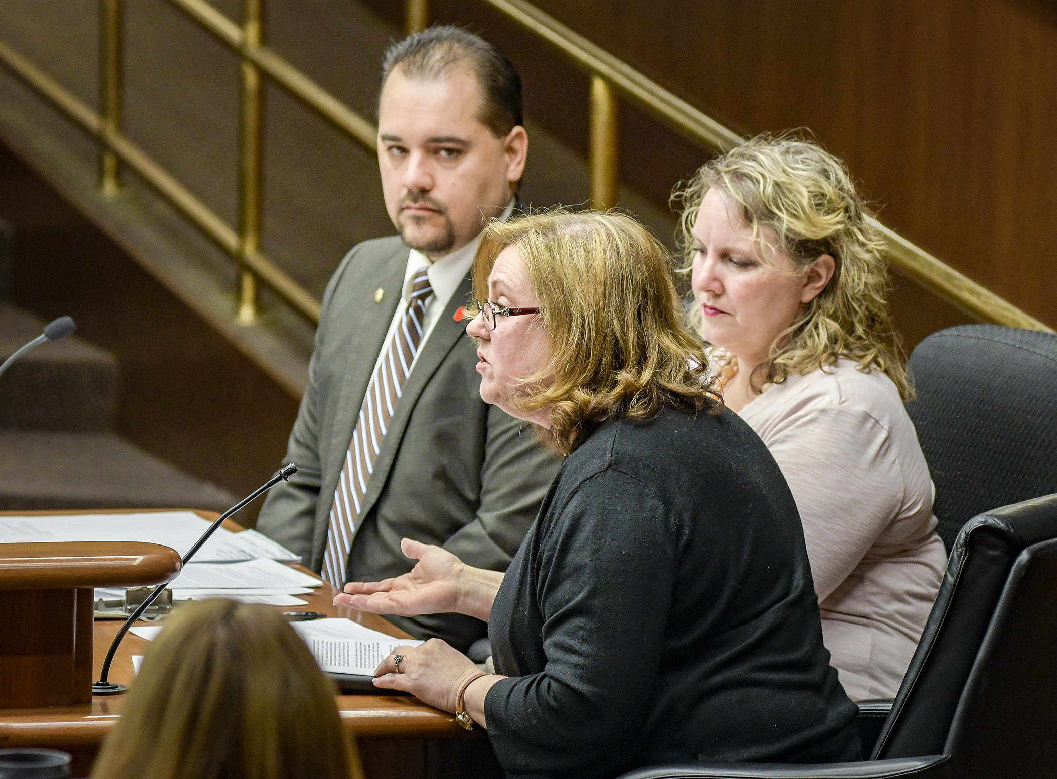 Representing Minnesota Advocates and Champions of Children, Linda Bell, center, and Kerstin Schulz, right, testify before the House Civil Law and Data Practices Policy Committee March 6 in support of a bill sponsored by Rep. Eric Lucero, left, that would create a Student Data Privacy Act. Photo by Andrew VonBank